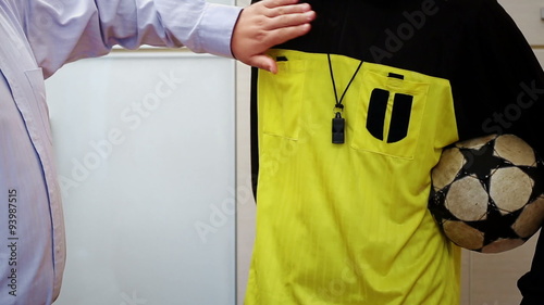 Sports referee accepting bribe money and putting it in his pocket