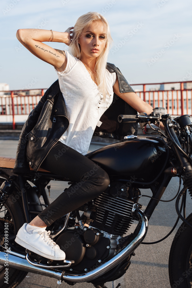 Biker girl sitting on vintage custom motorcycle Stock Photo Adobe Stock