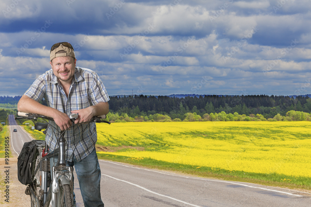 Obraz premium Road in blooming field yellow flowers summer landscape at
