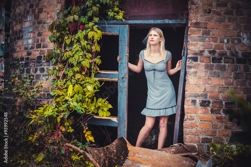 The girl in the dress looks out of the window, vintage, style, fashion
