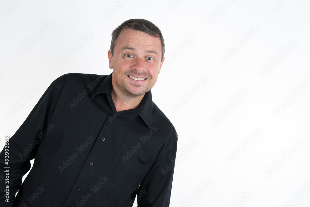 Man, unshaven, with black shirt looking at the camera