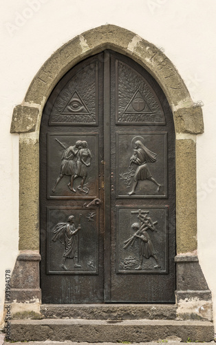 Ancient iron door handle on iron medieval door in Canazei, italy. #93994378