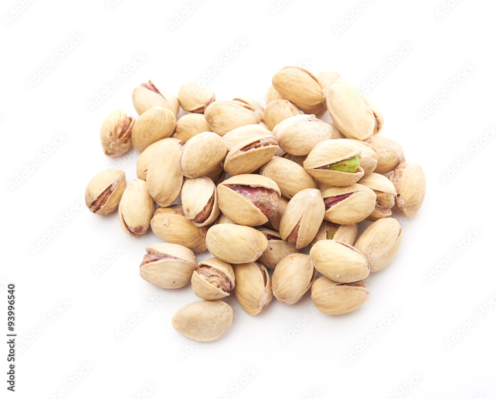 Heap of pistachios nuts isolated on the white Heap of pistachios nuts isolated on the white