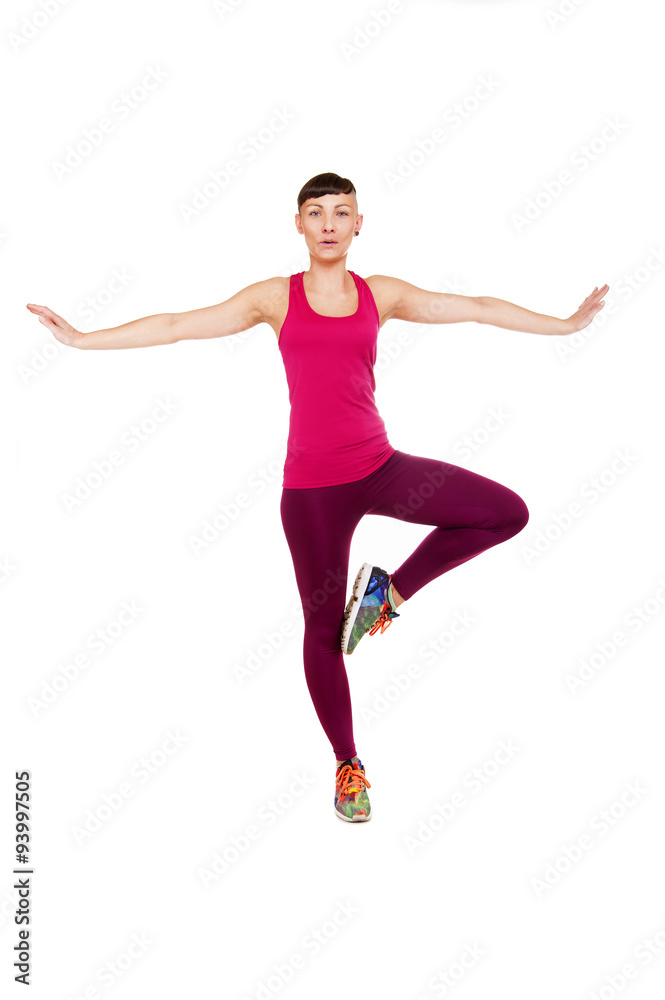 Young fitness woman balance, isolated over white background.