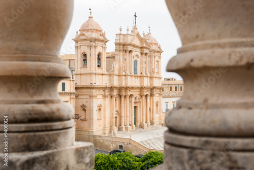 The baroque cathedral of Noto (UNESCO site in Sicily), seen through two columns photo