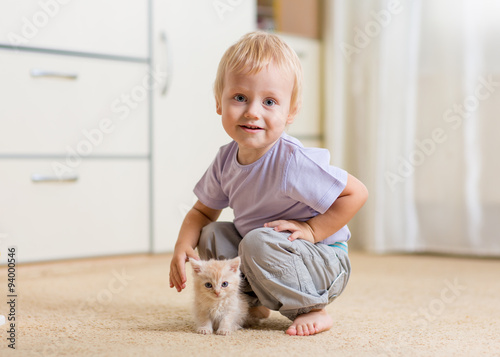 Toddler kid boy playing wit...