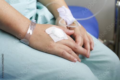 woman patient in hospital with saline intravenous (iv) © toa555