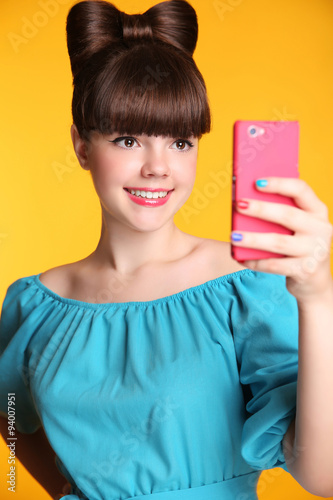 Happy smiling funny teen girl Taking Selfie Photo on Smart Phone