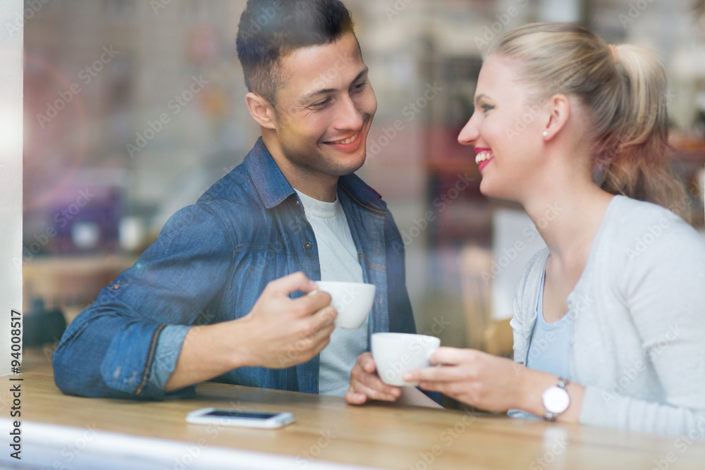 Young couple seen through cafe window