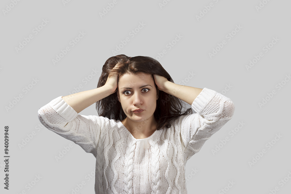 Closeup portrait headshot terrified young woman looking shocked, surprised, full disbelief, hand on head isolated grey background. Negative emotion facial expression feeling reaction Closeup portrait headshot terrified young woman looking shocked, surprised, full disbelief, hand on head isolated grey background. Negative emotion facial expression feeling reaction