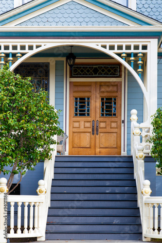Front door of an old blue Victorian house 