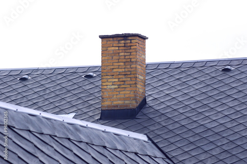 Fototapet old brick chimney on roof