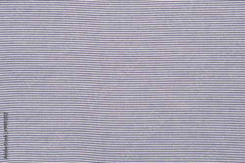 Striped blue and white textile pattern as a background. Close up on horizontal stripes material texture fabric.