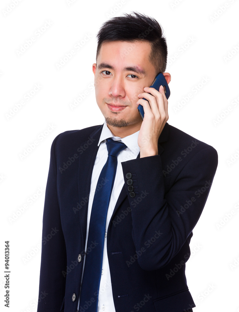 Asian Young businessman talk to mobile phone Asian Young businessman talk to mobile phone