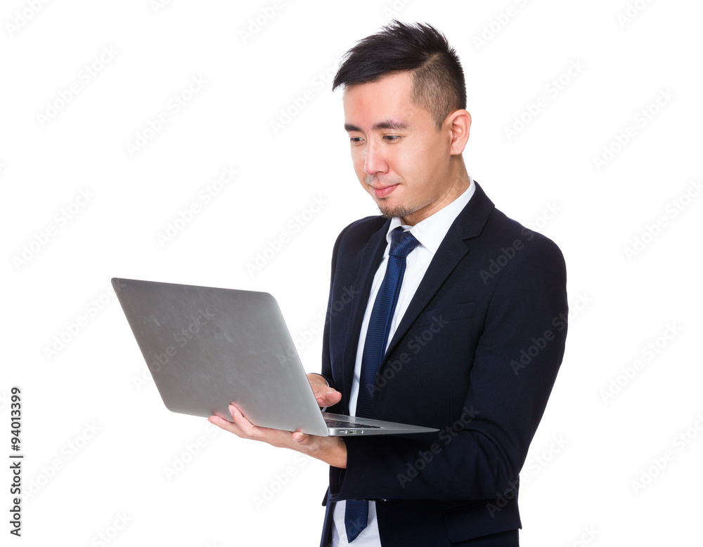 Asian businessman use of the notebook computer Asian businessman use of the notebook computer