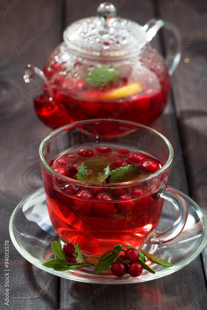 berry tea in cup on dark wooden table