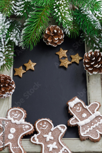Black board for text, fir branches and gingerbread man