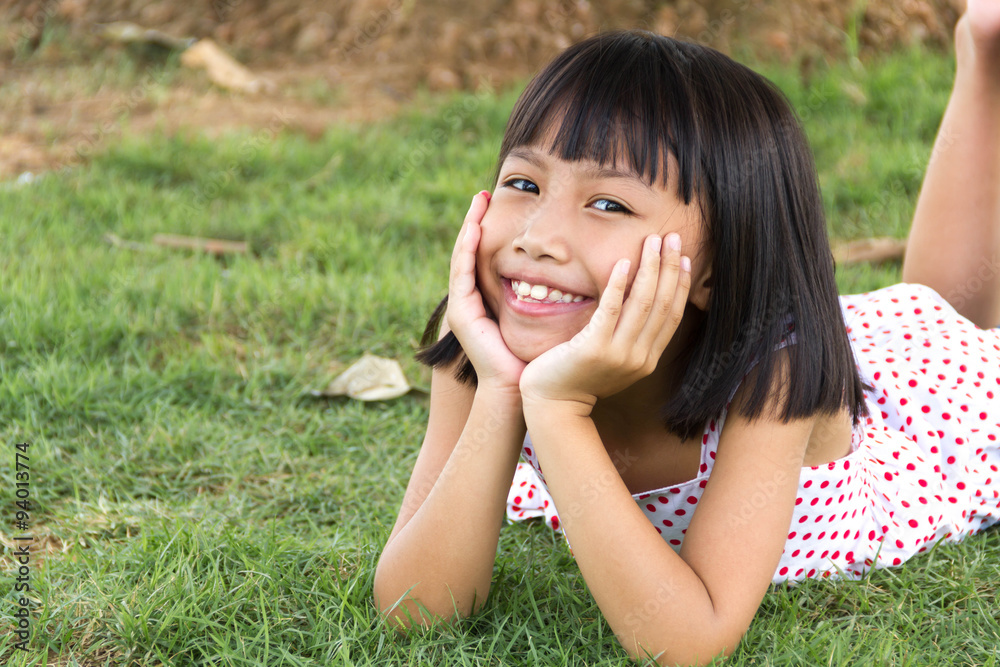Happy little girl having fun and smiling at the park Happy little girl having fun and smiling at the park
