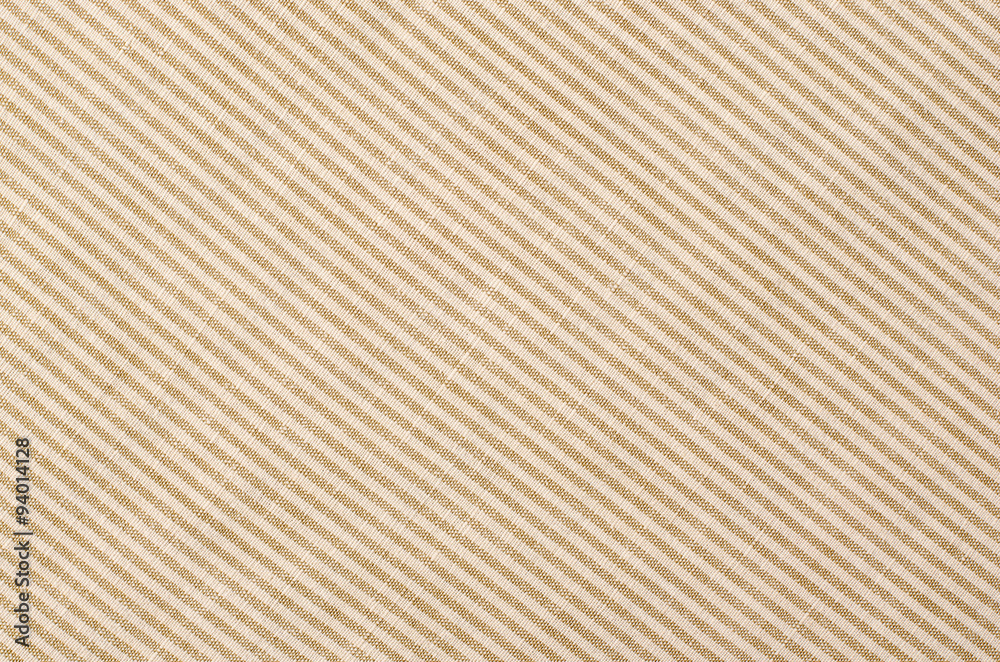Striped brown and beige textile pattern as a background. Close up on diagonal stripes material texture fabric. Striped brown and beige textile pattern as a background. Close up on diagonal stripes material texture fabric.