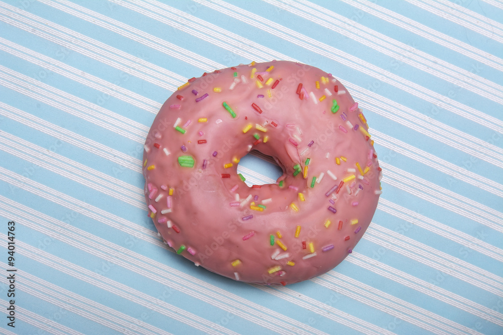 pink donut on blue striped background pink donut on blue striped background