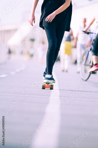 Close view of legs and skateboard 