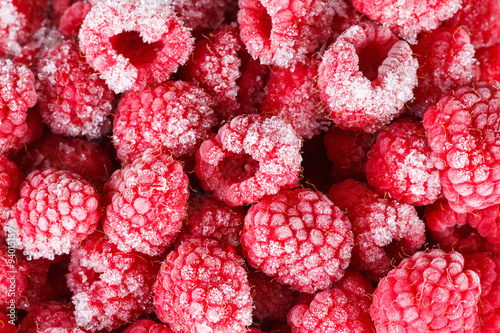 Frozen ripe raspberries background