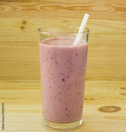 Smoothie with strawberry and white straw