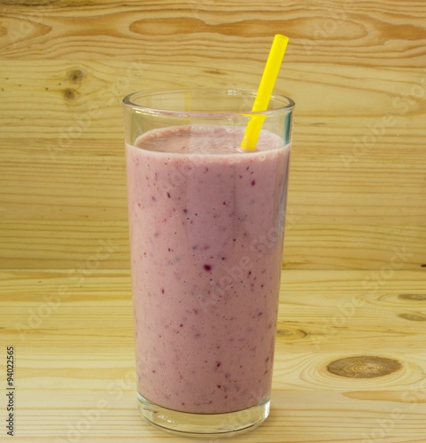 Smoothie with strawberry and yellow straw