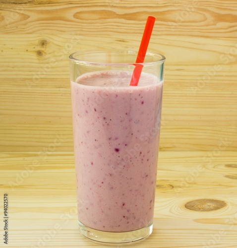 Smoothie with strawberry and red straw