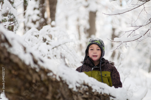 child out in a snowy forest
