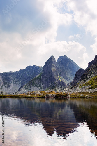 Mountain peak reflecting in a lake in Retezat mountains
