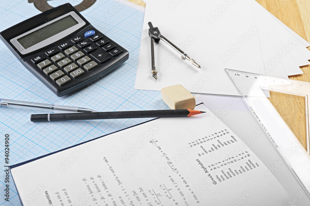 School supplies and textbook on mathematics close up School supplies and textbook on mathematics close up