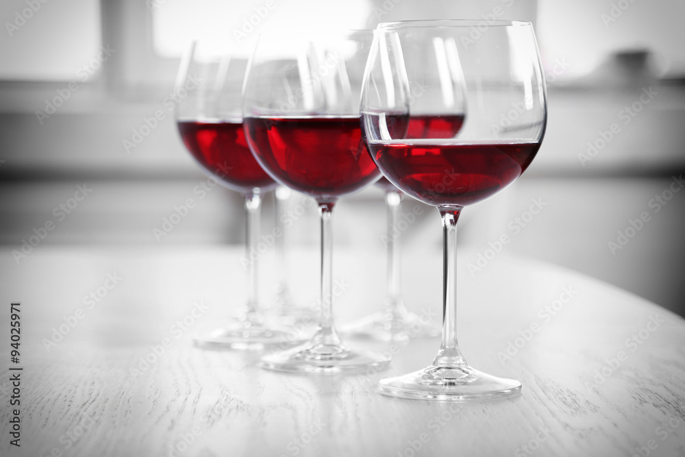 Wine glasses in restaurant on light background