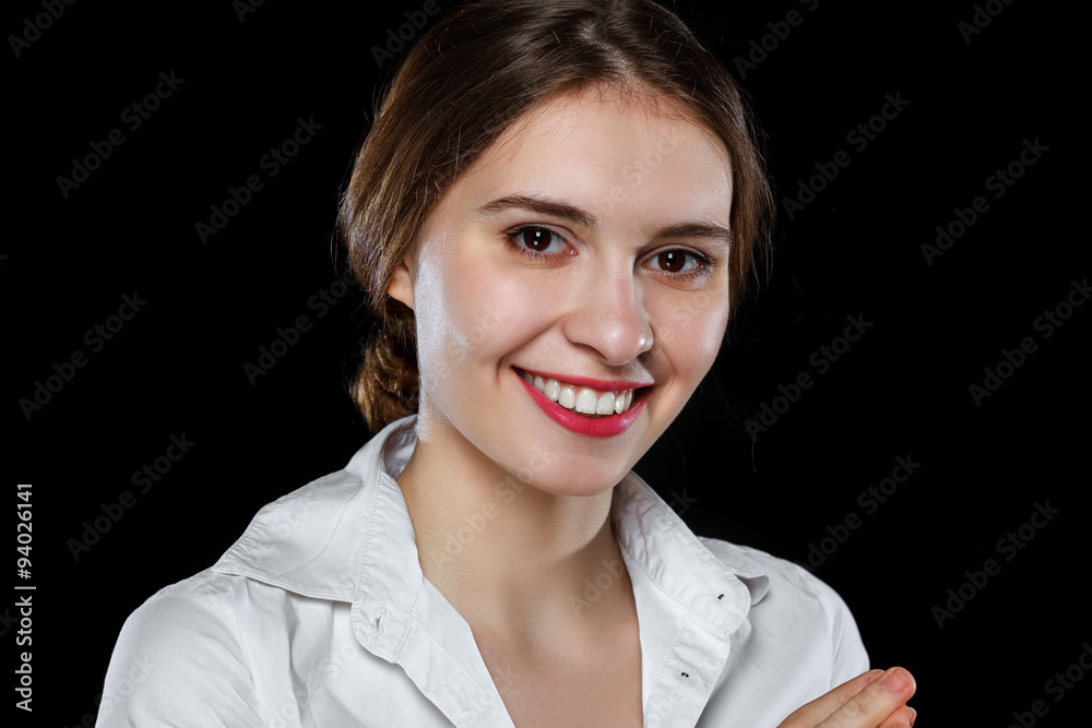 Young casual woman isolated over black background
