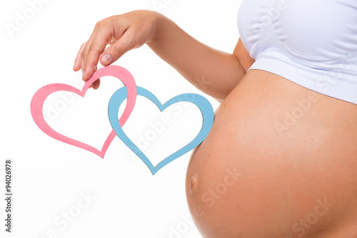 Wallpaper Mural Pregnant belly with blue and pink heart. Horizontal closeup. Determine the sex of the child: twins, girl or boy. Torontodigital.ca