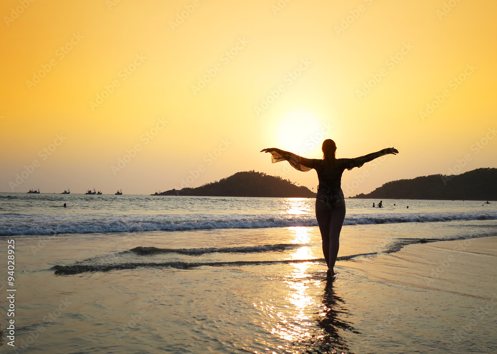 Young woman meditating on Agonda beach. South Goa, India