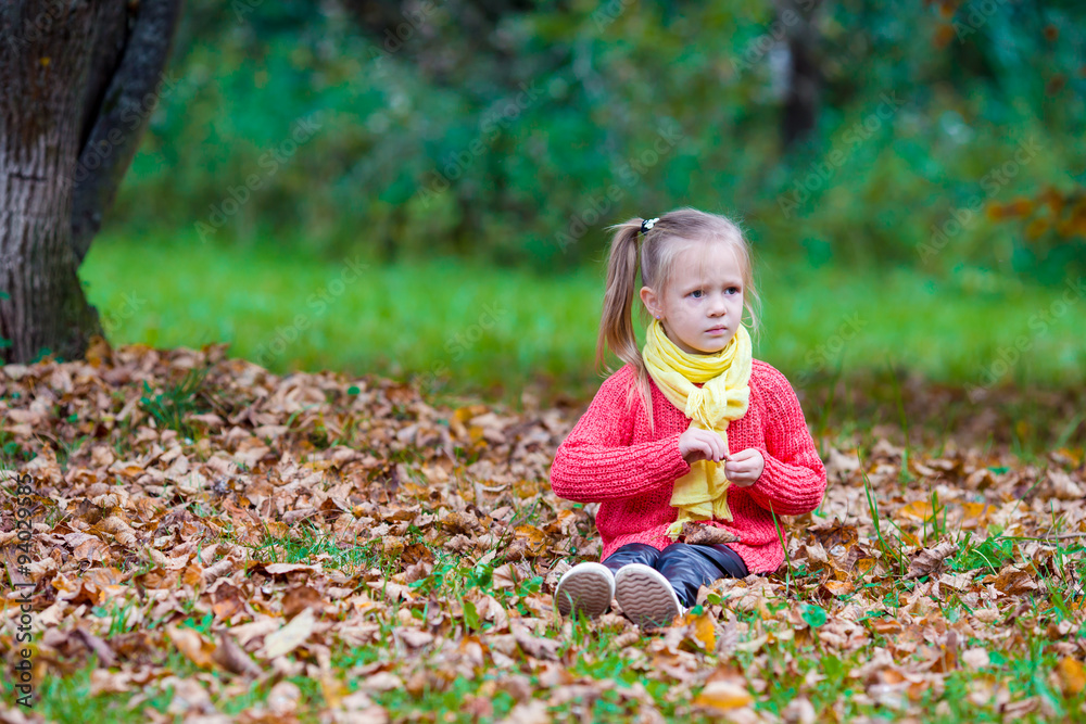 Adorable little girl outdoors at beautiful warm day in autumn Adorable little girl outdoors at beautiful warm day in autumn