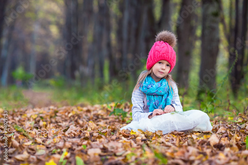 Adorable little girl outdoors at beautiful autumn day