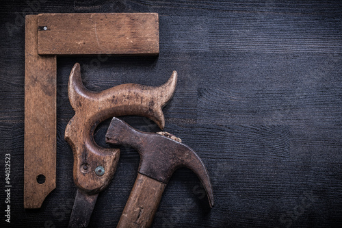 Vintage rusted tools on wood board construction concept