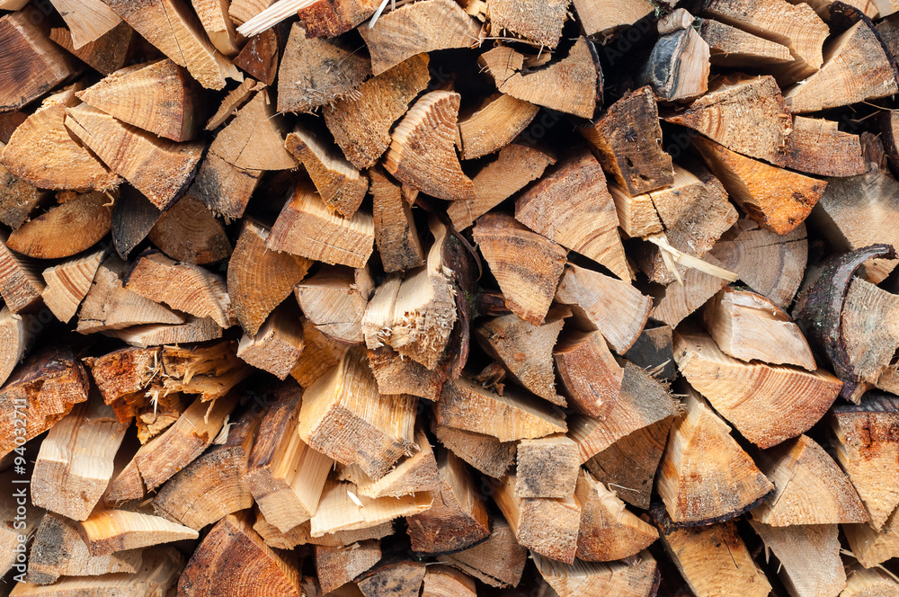 Background of dry chopped firewood logs in a pile Background of dry chopped firewood logs in a pile