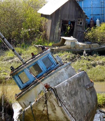 Obraz na płótnie Old boat tipped over at Finn Slough, Fraser River, Richmond, British Columbia, C