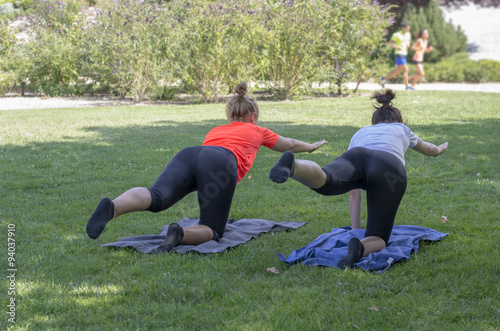 Pretty women are doing yoga exercises.
