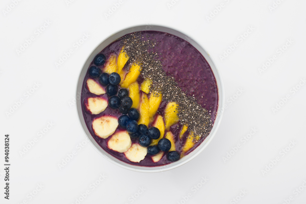 acai smoothie bowl topped with chia seeds, mango slices, blueberries and bananas acai smoothie bowl topped with chia seeds, mango slices, blueberries and bananas