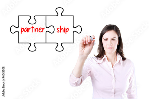 Businesswoman drawing a Partnership Puzzle Concept on the virtual screen.