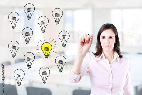 Business woman drawing a great idea concept. Office background.