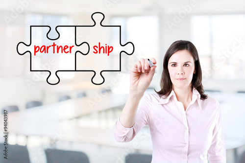 Businesswoman drawing a Partnership Puzzle Concept on the virtual screen. Office background. Free Download Businesswoman drawing a Partnership Puzzle Concept on the virtual screen. Office background. - GFXLoad