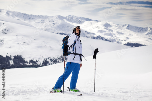 Cross-country skier - snowy mountains in the background