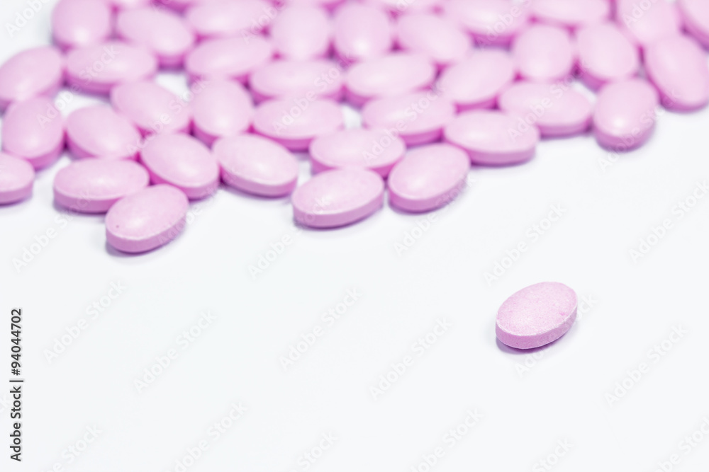 The pink tablets isolated on white background The pink tablets isolated on white background