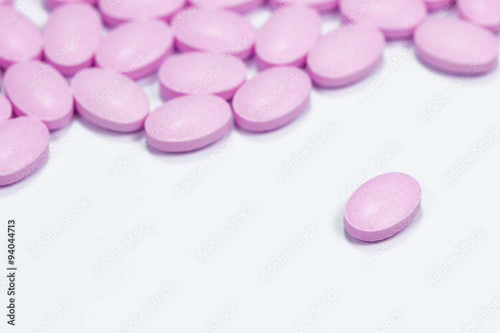 The pink tablets isolated on white background The pink tablets isolated on white background