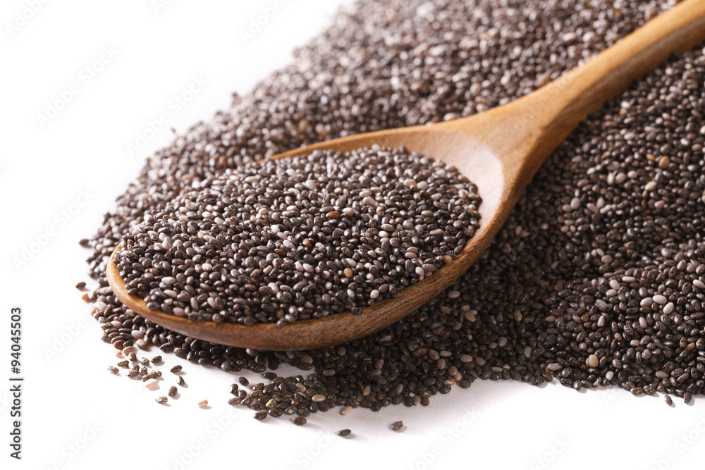 Chia seeds macro in a wooden spoon isolated on a white. Horizontal Chia seeds macro in a wooden spoon isolated on a white. Horizontal